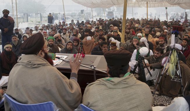Supporters of religious groups listen to their leader at a rally to express solidarity with protesters, in Lahore, Pakistan, Sunday, Nov. 26, 2017. Pakistani Islamists are pressing ahead with their rally near Islamabad in even larger numbers, a day after clashes with police left six dead and dozens wounded. (AP Photo/K.M. Chaudary)