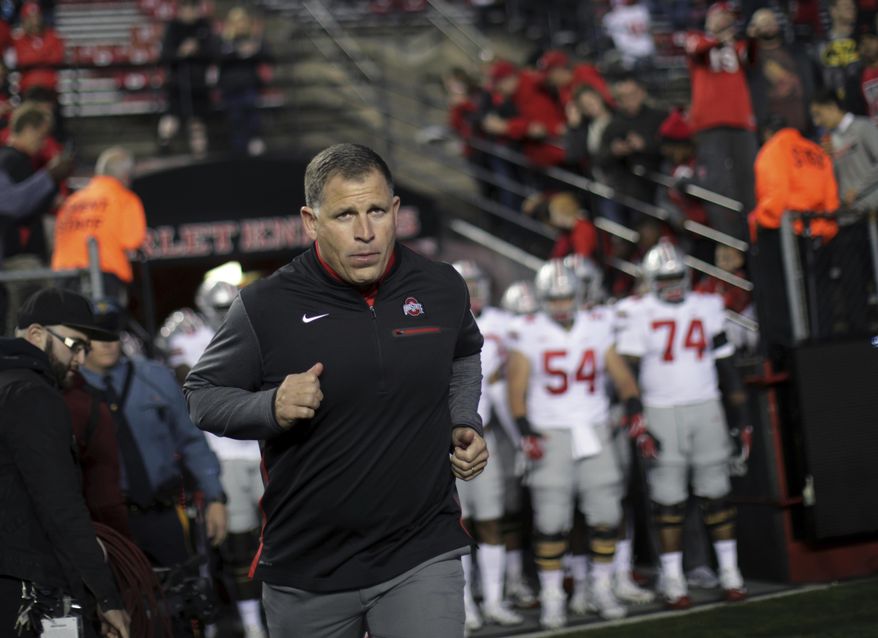 FILE- This Sept. 30, 2017 file photo shows former Rutgers football head coach, now Ohio State associate head coach/defensive coordinator Greg Schiano running onto the field before an NCAA college football game against Rutgers in Piscataway, N.J. Ohio State coach Urban Meyer says Tennessee has contacted Schiano about its head coaching vacancy. Meyer didn't have any additional details about Tennessee's potential interest in his defensive coordinator. Tennessee is seeking a new coach after firing Butch Jones two weeks ago. Schiano posted a 68-67 record as Rutgers' coach from 2001-11. (AP Photo/Mel Evans, file) **FILE**
