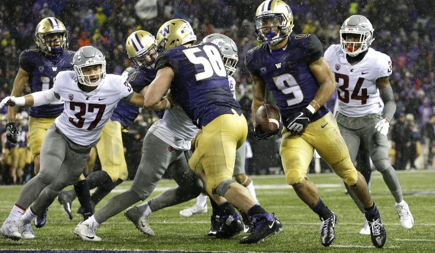 Washington running back Myles Gaskin (9) rushes for a touchdown against Washington State during the second half of an NCAA college football game, Saturday, Nov. 25, 2017, in Seattle. It was Gaskin's fourth touchdown of the game. (AP Photo/Ted S. Warren)