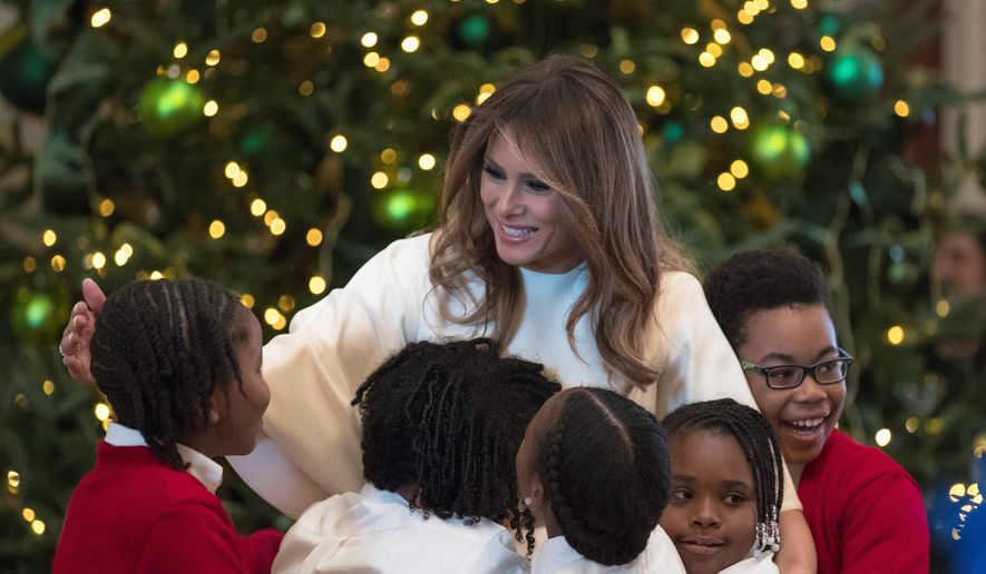 First lady Melania Trump is greeted by children as she arrives to visits with them in the East Room among the 2017 holiday decorations with the theme &quot;Time-Honored Traditions&quot; at the White House. (Associated Press)