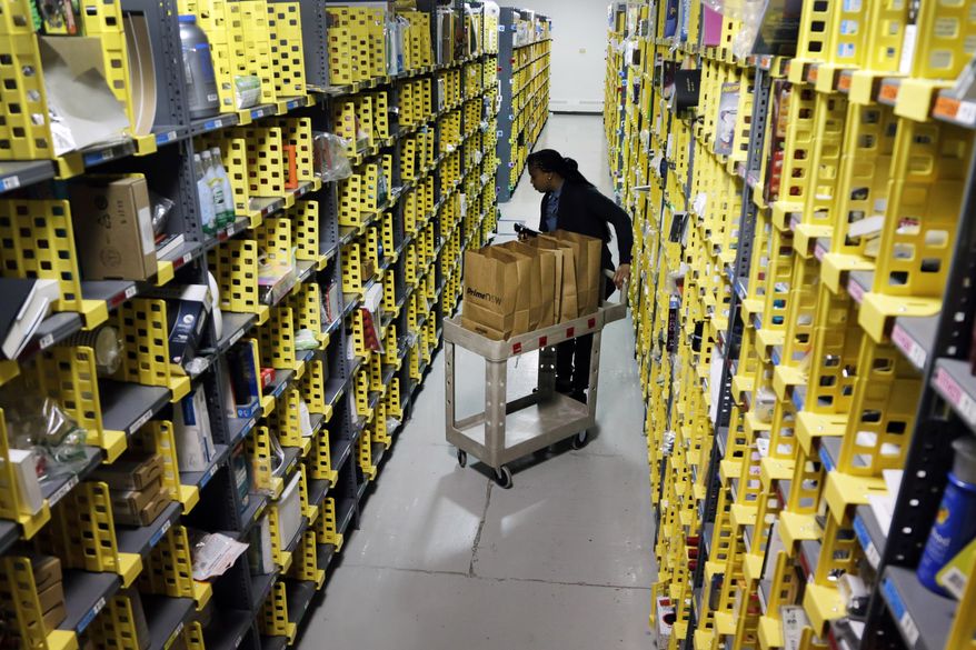 In this Tuesday, Dec. 22, 2015, file photo, Amazon Prime employee Alicia Jackson hunts for items at the company's urban fulfillment facility that have been ordered by customers, in New York. Shoppers are expected to spend $6.6 billion on Cyber Monday, Nov. 27, 2017, up more than 16 percent from a year ago, according to Adobe Analytics, the research arm of software maker Adobe. And more people will be picking up their phones to shop: Web traffic from smartphones and tablets is expected to top desktop computers for the first time this year, Adobe said. (AP Photo/Mark Lennihan, File)