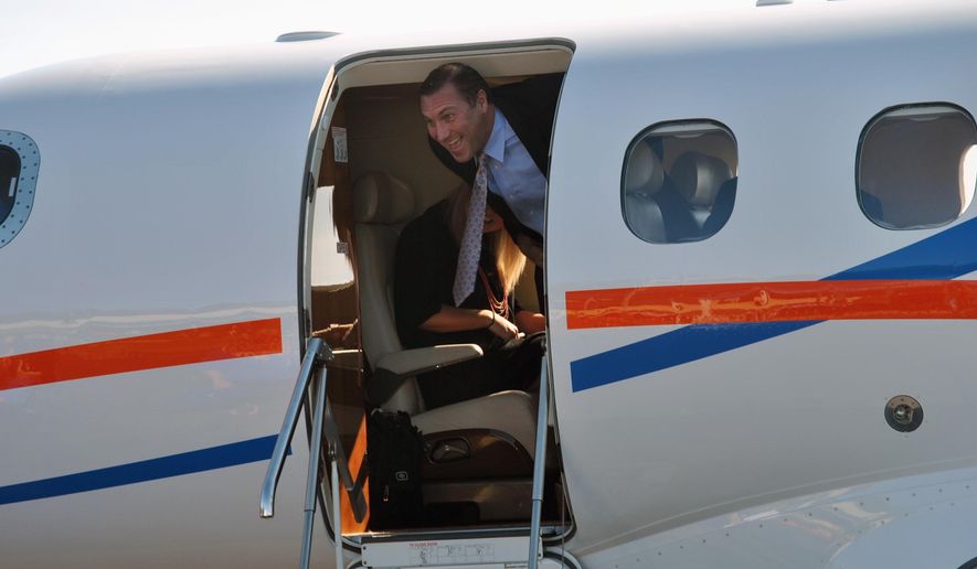 University of Florida&#39;s new NCAA college football coach Dan Mullen smiles as he arrives at the airport in Gainesville, Fla., Monday, Nov. 27, 2017. (AP Photo/Mark Long)