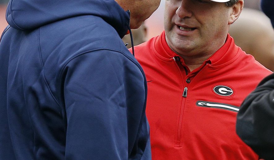 FILE - In this Nov. 11, 2017, file photo, Auburn head coach Gus Malzahn, left, and Georgia head coach Kirby Smart, right, meet before an NCAA college football game in Auburn, Ala. No. 6 Georgia is getting ready for a rematch with No. 4 Auburn in the SEC championship game. (AP Photo/Brynn Anderson, File)