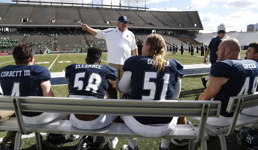 Rice head coach David Bailiff, center, talks with his team before an NCAA college football game against North Texas at Rice Stadium, Saturday, Nov. 25, 2017, in Houston. (Karen Warren/Houston Chronicle via AP)