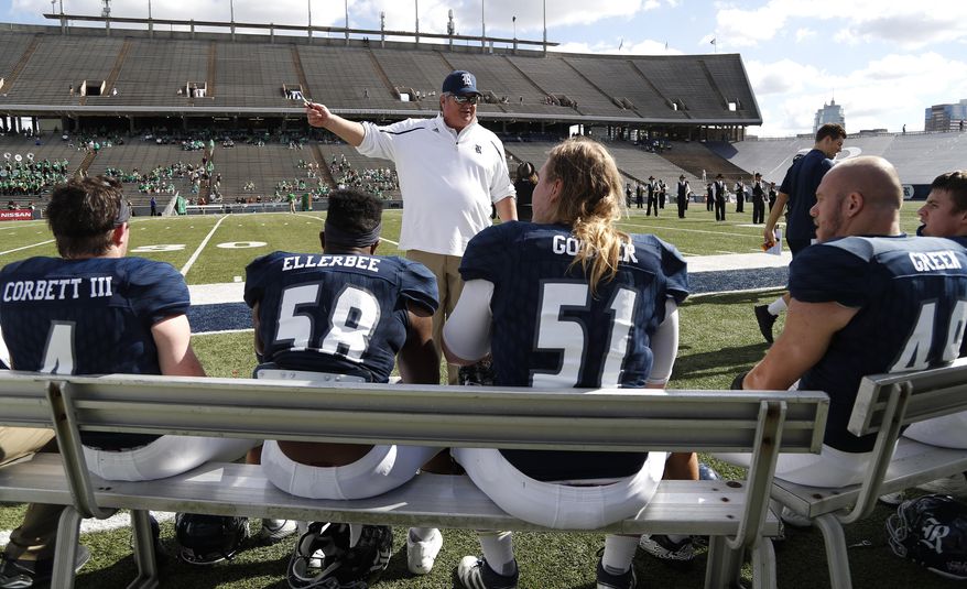 Rice head coach David Bailiff, center, talks with his team before an NCAA college football game against North Texas at Rice Stadium, Saturday, Nov. 25, 2017, in Houston. (Karen Warren/Houston Chronicle via AP)