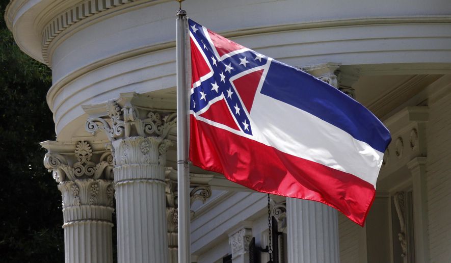 FILE - In this June 23, 2015, file photo, the Mississippi state flag is unfurled against the front of the Governor's Mansion in Jackson, Miss. The U.S. Supreme Court on Monday, Nov. 27, 2017, rejected an appeal from African-American attorney Carlos Moore who called the Confederate battle emblem on the Mississippi flag "an official endorsement of white supremacy." The justices did not comment as they ended the lawsuit by Moore that sought to have the flag declared an unconstitutional relic of slavery. (AP Photo/Rogelio V. Solis, File)