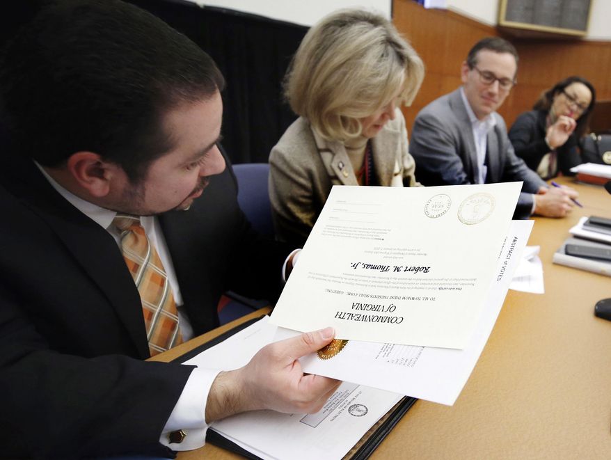 The Virginia State Board of Elections certifies the results in the contested 28th and 88th House of Delegates Districts elections, Monday, Nov. 27, 2017, in Richmond, Va. Getting the nod in the 28th, Republican Robert M.Thomas Jr. was selected to replace retiring GOP Speaker William J. Howell and in the 88th, incumbent Mark Cole (R-Spotsylvania) will return in January. Signing the official paperwork, from left: Edgardo Cortes, board member; Clara Bell Wheeler, vice-chair; James B. Alcorn, chair and Singleton McAllister, board secretary. (Joe Mahoney/Richmond Times-Dispatch via AP)