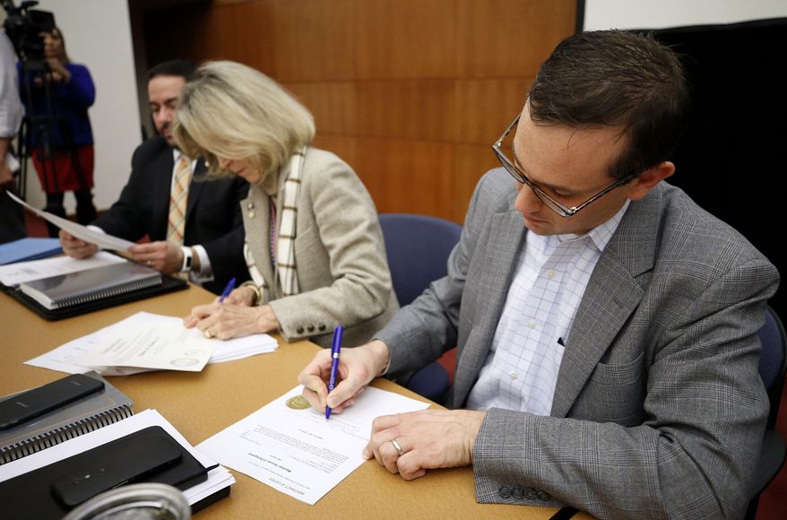 James B. Alcorn, at right, chairman of The Virginia State Board of Elections certifies the results in the contested 28th and 88th House of Delegates Districts elections, Monday, Nov. 27, 2017 in Richmond,, Va. Getting the nod in the 28th, Republican Robert M. Thomas Jr. was selected to replace retiring GOP Speaker William J. Howell and in the 88th, incumbent Mark Cole (R-Spotsylvania) will return in January. At left is board member Edgardo Cortes and Vice-Chair Clara Bell Wheeler. ( Joe Mahoney/Richmond Times-Dispatch via AP)