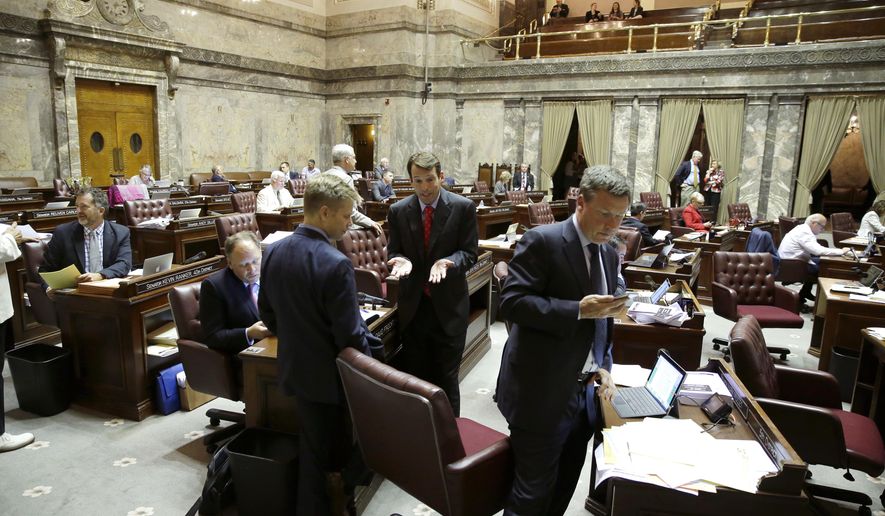 FILE - In this June 30, 2017 file photo, the public gallery is visible above the Senate floor at upper right in the Capitol in Olympia, Wash. All firearms will be banned from the public galleries above the Washington Senate floor starting next session, even concealed weapons carried with a permit. Lt. Gov. Cyrus Habib issued the order, saying his goal is to create a safe environment in the chamber. (AP Photo/Ted S. Warren, file)