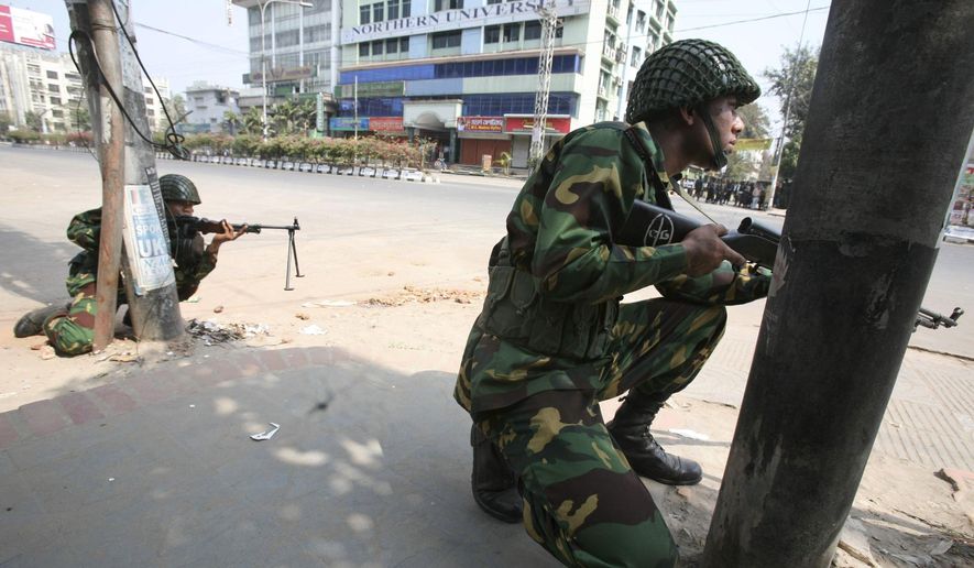 In this Feb. 25, 2009 file photo, Bangladesh army soldiers take positions near the headquarters of Bangladesh Rifles in Dhaka. In 2013, a trial court sentenced 152 people to death, but in response to an appeal, the High Court commuted the sentences for eight of them to life in prison and acquitted four others. Another man died during the 370 days of proceedings before Monday's verdict. A total of 846 people, mostly border guards, are facing trial. (AP Photo/Pavel Rahman, File)
