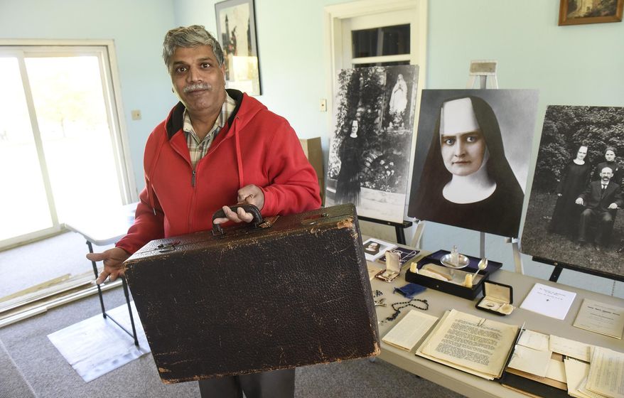 ADVANCE FOR WEEKEND EDITIONS, DEC. 2-3 - In this Oct. 24, 2017 photo, Patrick Norton holds a suitcase owned by Sister M. Annella Zervas at his home in St. Joseph, Minn. Norton says Zervas appeared to him seven years ago while he was working on campus at the College of St. Benedict. He is working to have her recognized as a saint. (Dave Schwarz/St. Cloud Times via AP)