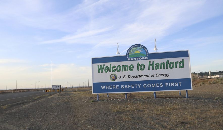 FILE - In this May 9, 2017 file photo, a sign welcomes drivers to Hanford Nuclear Reservation in Richland, Wash. After almost two decades of work, the government has nearly finished removing radioactive wastes from a first group of underground storage tanks in eastern Washington. (AP Photo/Manuel Valdes, file)