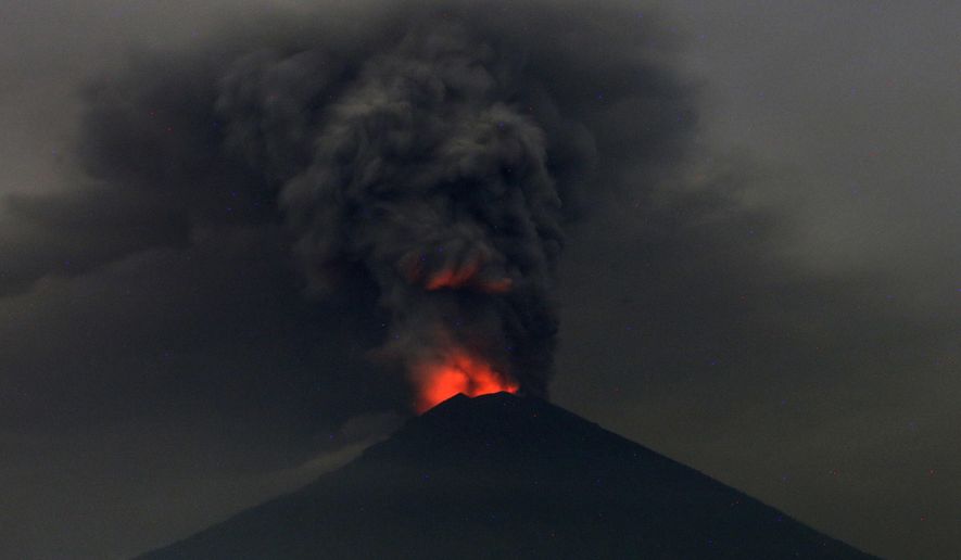 This Monday, Nov. 27, 2017, file photo, shows Mount Agung volcano erupting in Karangasem, Bali, Indonesia. Mount Agung volcano on Bali has erupted for the first time in more than half a century, forcing closure of the Indonesian tourist island&#39;s busy airport as the mountain gushes huge columns of ash that are a threat to airplanes. (AP Photo/Firdia Lisnawati, File)