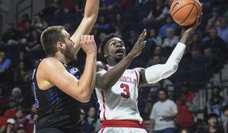 Mississippi&#39;s Terence Davis (3) shoots against South Dakota State&#39;s Mike Daum (24) in an NCAA college basketball game in Oxford, Miss., Tuesday, Nov. 28, 2017. (Bruce Newman/The Oxford Eagle via AP)