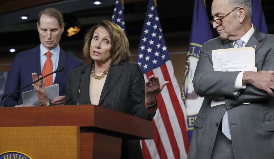 In this Nov. 2, 2017, file photo, House Minority Leader Nancy Pelosi, D-Calif., flanked by Sen. Ron Wyden, D-Ore., the ranking member of the Senate Finance Committee, left, and Senate Minority Leader Chuck Schumer, D-N.Y., holds a news conference on Capitol Hill to respond to the Republican tax reform plan in Washington. (AP Photo/J. Scott Applewhite)