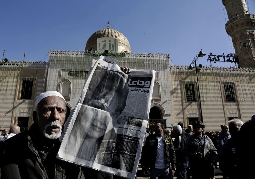 A man hold a newspaper with the photo of Egyptian singer and actress Shadia, during her funeral procession, at the Sayeda Nafisa Mosque in Cairo, Egypt, Wednesday, Nov. 29, 2017. Shadia died at the age of 86. (AP Photo/Nariman El-Mofty)