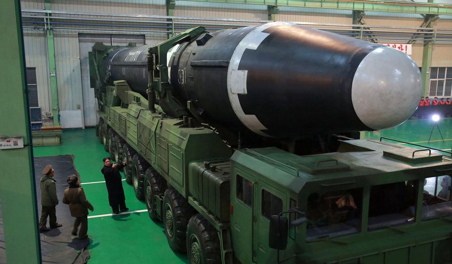 This Nov. 29, 2017, image provided by the North Korean government on Thursday, Nov. 30, 2017, shows North Korean leader Kim Jong Un, third from left, and what the North Korean government calls the Hwasong-15 intercontinental ballistic missile, in North Korea. Independent journalists were not given access to cover the event depicted in this image distributed by the North Korean government. The content of this image is as provided and cannot be independently verified. (Korean Central News Agency/Korea News Service via AP)