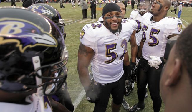 FILE - In this Dec. 26, 2010, file photo, Baltimore Ravens linebacker Ray Lewis (52) inspires his teammates, including linebacker Terrell Suggs (55), before an NFL football game against the Cleveland Browns in Cleveland. Lewis played on many a great defense with the Baltimore Ravens, including the 2000 team that won a Super Bowl and set an NFL record for fewest points allowed in a 16-game season. (AP Photo/Amy Sancetta, File)