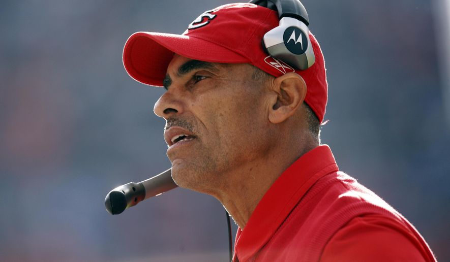 FILE - In this Dec. 7, 2008, file photo, Kansas City Chiefs coach Herm Edwards watches the team's NFL football game against the Denver Broncos in Denver. A person with direct knowledge of the plan has told The Associated Press that Edwards is in line to become Arizona State's next coach, pending approval of the university president. The official spoke to the AP on the condition of anonymity Wednesday night, Nov. 29, 2017, because the deal and official announcement are still being finalized. Edwards has not coached since 2008, when he was fired after a 2-14 season with the Chiefs. He also coached the New York Jets from 2001-05 and has spent the last nine years as an analyst for ESPN. (AP Photo/David Zalubowski, File)