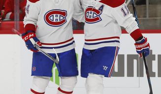 Montreal Canadiens right wing Brendan Gallagher, right, celebrates his goal against the Detroit Red Wings with Charles Hudon in the third period of an NHL hockey game Thursday, Nov. 30, 2017, in Detroit. (AP Photo/Paul Sancya)