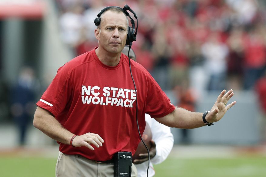 In this Saturday, Nov. 4, 2017 file photo, North Carolina State head coach Dave Doeren reacts during the first half of an NCAA college football game against Clemson in Raleigh, N.C. A person with knowledge of the situation says North Carolina State and Dave Doeren have agreed on a five-year deal after the coach had talked with Tennessee officials about the school’s opening. The person spoke to The Associated Press Thursday, Nov. 30, 2017 on condition of anonymity because N.C. State hasn’t publicly announced the agreement. (AP Photo/Gerry Broome, File)