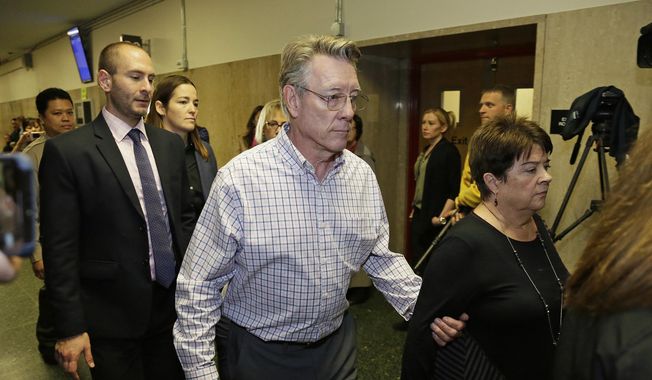In this Nov. 30, 2017 file photo, Jim Steinle, center, and Liz Sullivan, right, the parents of Kate Steinle, walk to a courtroom for closing arguments in the trial of Jose Ines Garcia Zarate accused of killing their daughter, in San Francisco. (AP Photo/Eric Risberg, File)