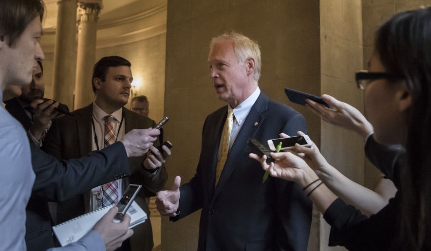 Sen. Ron Johnson, R-Wis., pauses for reporters on Capitol Hill in Washington, Friday, Dec. 1, 2017. (AP Photo/J. Scott Applewhite) ** FILE **