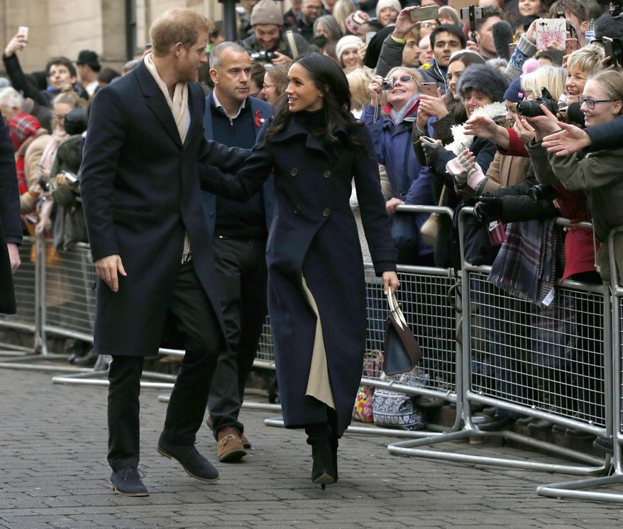 Britain's Prince Harry and his fiancee Meghan Markle arrive at the Terrence Higgins Trust World AIDS Day charity fair, in Nottingham, England, Friday, Dec. 1, 2017. The couple are taking part in their first official visit together, choosing to raise awareness of HIV/AIDS with a visit to a youth project in Nottingham.(AP Photo/Alastair Grant)