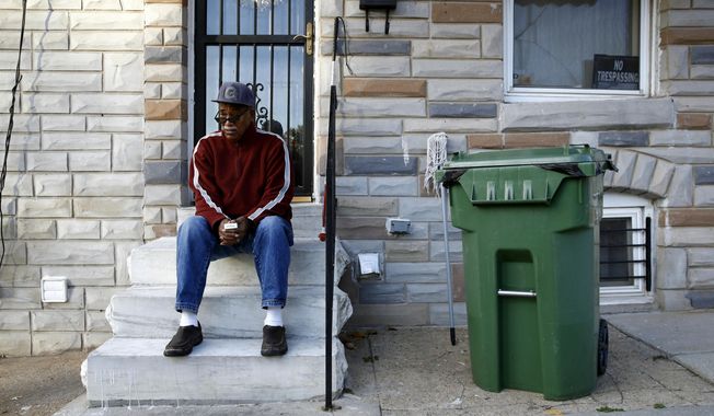 In this Nov. 27, 2017 photo, Harold Perry sits on a stoop in front of his home, across the street from the site of Freddie Gray&#x27;s arrest, in the Sandtown-Winchester neighborhood of Baltimore. These days, it&#x27;s hard to find anyone in this neighborhood of generational poverty and disenfranchisement who admits to believing that police involved Gray&#x27;s arrest might somehow be held responsible. &amp;quot;There was never going to be any justice,&amp;quot; Perry said bitterly. &amp;quot;Maybe someone had hopes once upon a time, but justice is a very hard thing to come by around here.&amp;quot; (AP Photo/Patrick Semansky)