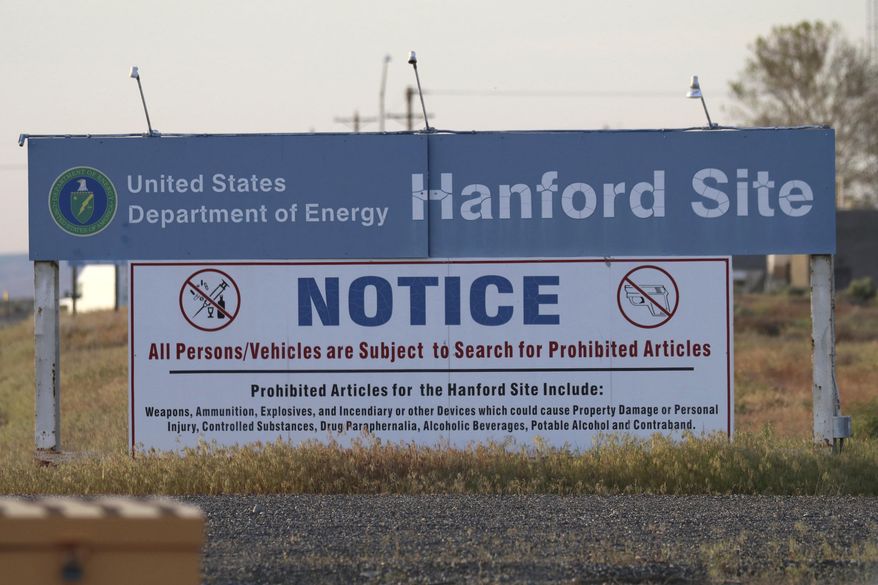FILE - In this May 9, 2017, file photo, signs are posted by the Hanford Nuclear Reservation in Richland, Wash. By conducting some of the most high-tech research in the world, maintaining the U.S. stockpile of nuclear weapons and cleaning up after decades of bomb-making, the Department of Energy has its share of management challenges. A report released this week outlines some of those challenges while providing a look at the expansive scope of the department's responsibilities and costly liabilities. (AP Photo/Manuel Valdes, File)