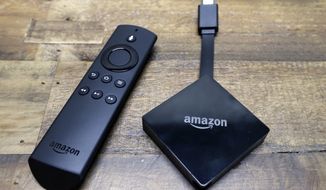 FILE - This Wednesday, Sept. 27, 2017, file photo shows an Amazon Fire TV streaming device displayed with its remote. The device plugs into the back or side of a television set to stream Netflix and other video. Although Amazon has gotten better about promoting rival services, Fire TV is best seen as a companion to Amazon’s $99-a-year Prime loyalty program. (AP Photo/Elaine Thompson, File)