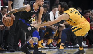 Los Angeles Clippers guard Austin Rivers, left, handles the ball as Utah Jazz guard Ricky Rubio defends during the first half of an NBA basketball game in Los Angeles, Thursday, Nov. 30, 2017. (AP Photo/Kelvin Kuo)
