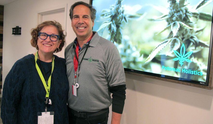 Louise Fisher and William Askinazi, who are co-owners of a medical marijuana dispensary called Potomac Holistics, stand in the store in Rockville, Md., on Friday, Dec. 1, 2017, hours before they were scheduled to receive their first shipment and begin selling medical marijuana, among the first dispensaries in the state to do so. (AP Photo/Brian Witte)