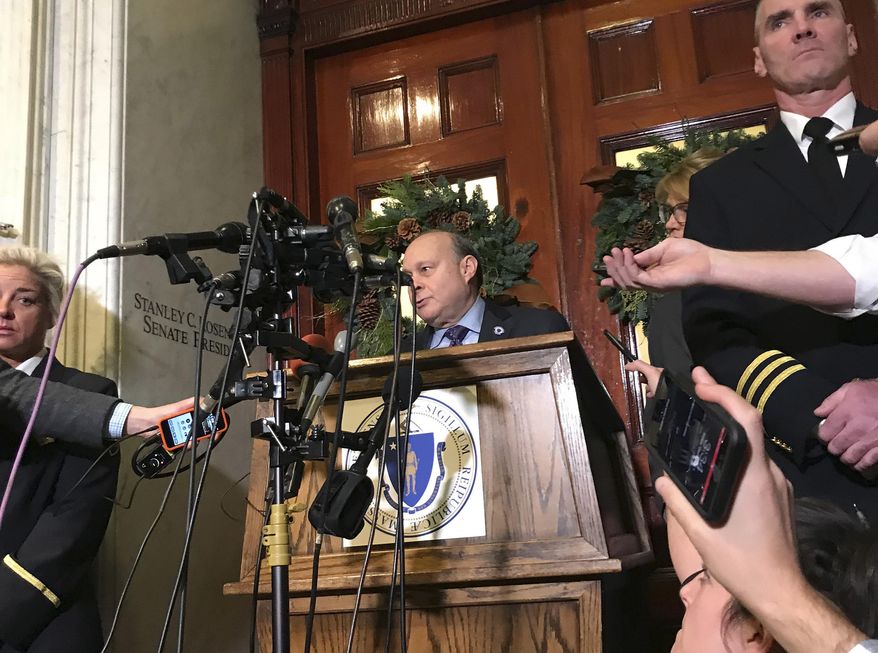 Massachusetts Senate President Stan Rosenberg speaks from behind a podium outside his office at the Statehouse to a throng of media Friday, Dec. 1, 2017, in Boston. Rosenberg said his husband, Bryon Hefner, will soon be entering treatment for alcoholism, one day after The Boston Globe reported that several men had accused Hefner of sexual assault and harassment. Some of the men had professional dealings with the Legislature. (AP Photo/Bob Salsberg)