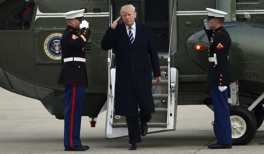 President Donald Trump salutes as he steps off of Marine One and walks towards Air Force One at John F. Kennedy International Airport in New York, Saturday, Dec. 2, 2017. Trump spent the day in New York attending a trio of fundraisers. (AP Photo/Susan Walsh)