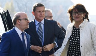 Former Trump national security adviser Michael Flynn, center, arrives at federal court in Washington, Friday, Dec. 1, 2017. (AP Photo/Susan Walsh)