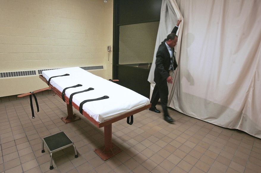 FILE – In this Nov. 2005 file photo, Larry Greene, public information director of the Southern Ohio Correctional Facility, demonstrates how a curtain is pulled between the death chamber and witness room at the prison in Lucasville, Ohio. More than three dozen inmates, one-third of them from Ohio, avoided scheduled trips to the death chamber this year after winning reprieves from courts. A court reprieve that halted the scheduled December lethal injection of a Texas prisoner means 2017 will end with 23 inmates executed in the U.S, a slight rise from a year ago, and Texas regaining its standing as the nation's most active state in carrying out capital punishment. (AP Photo/Kiichiro Sato, File)