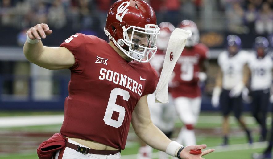Oklahoma quarterback Baker Mayfield celebrates throwing a touchdown pass to wide receiver Marquise Brown (5) in the second half of the Big 12 Conference championship NCAA college football game against TCU on Saturday, Dec. 2, 2017, in Arlington, Texas. (AP Photo/Tony Gutierrez)