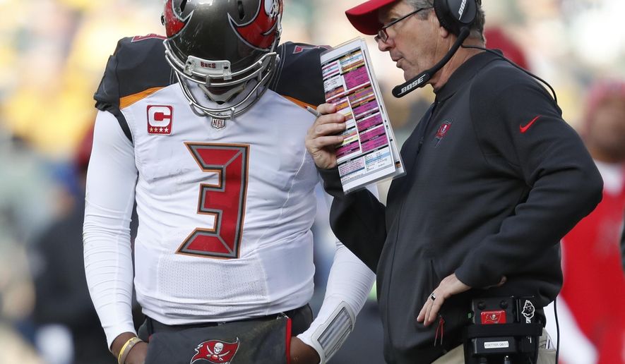 Tampa Bay Buccaneers head coach Dirk Koetter talks to quarterback Jameis Winston during the second half of an NFL football game against the Green Bay Packers Sunday, Dec. 3, 2017, in Green Bay, Wis. (AP Photo/Matt Ludtke)