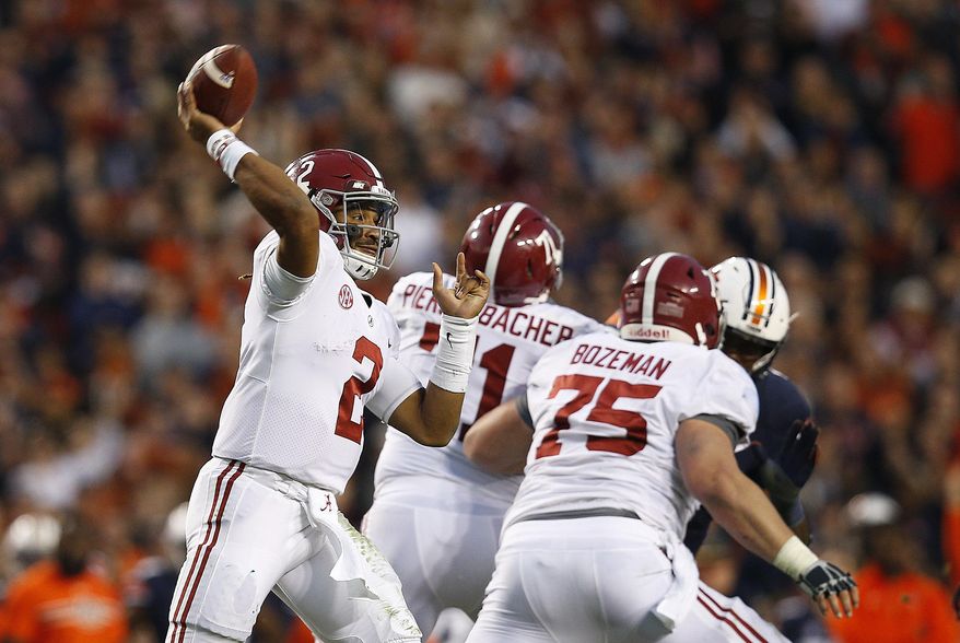 FILE - In this Nov. 25, 2017, file photo, Alabama quarterback Jalen Hurts throws the ball during the second half of the Iron Bowl NCAA college football game, in Auburn, Ala. The Associated Press voters prefer Alabama over Ohio State. In the final Top 25 of the regular season, the Crimson Tide was No. 4 and the Buckeyes were No. 5. (AP Photo/Brynn Anderson, File) **FILE**