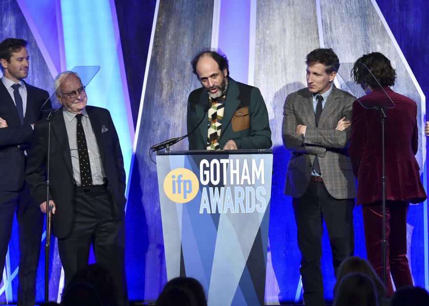 FILE - In this Nov. 27, 2017, file photo, director Luca Guadagnino, center, accepts the best feature award for "Call Me By Your Name" at the 27th annual Independent Film Project's Gotham Awards at Cipriani Wall Street in New York. The Los Angeles Film Critics Association announced Sunday, Dec. 3, on Twitter that it has voted "Call Me By Your Name" the best film of the year, bestowing a total of three awards on Guadagnino's erotic coming-of-age tale. (Photo by Evan Agostini/Invision/AP, File)