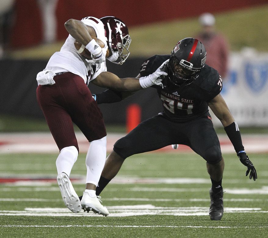 Troy quarterback Sawyer Smith (3) shoves away Arkansas State defensive back Darreon Jackson (34) during the first quarter of an NCAA college football game Saturday, Dec. 2, 2017, in Jonesboro, Ark. (Tommy Metthe//The Arkansas Democrat-Gazette via AP)