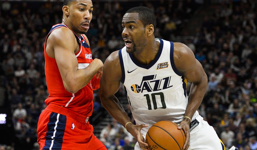 Washington Wizards forward Otto Porter Jr., left, attempts to guard againstUtah Jazz guard Alec Burks, right, in the second half of an NBA basketball game Monday, Dec. 4, 2017, in Salt Lake City. (AP Photo/Alex Goodlett)