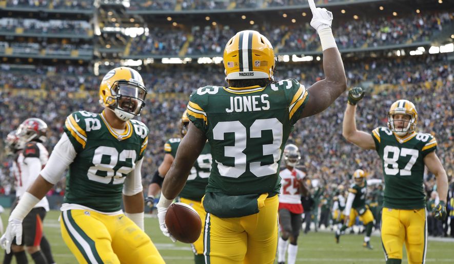 Green Bay Packers' Aaron Jones celebrates his touchdown run during overtime of an NFL football game against the Tampa Bay Buccaneers Sunday, Dec. 3, 2017, in Green Bay, Wis. The Packers won 26-20. (AP Photo/Mike Roemer)