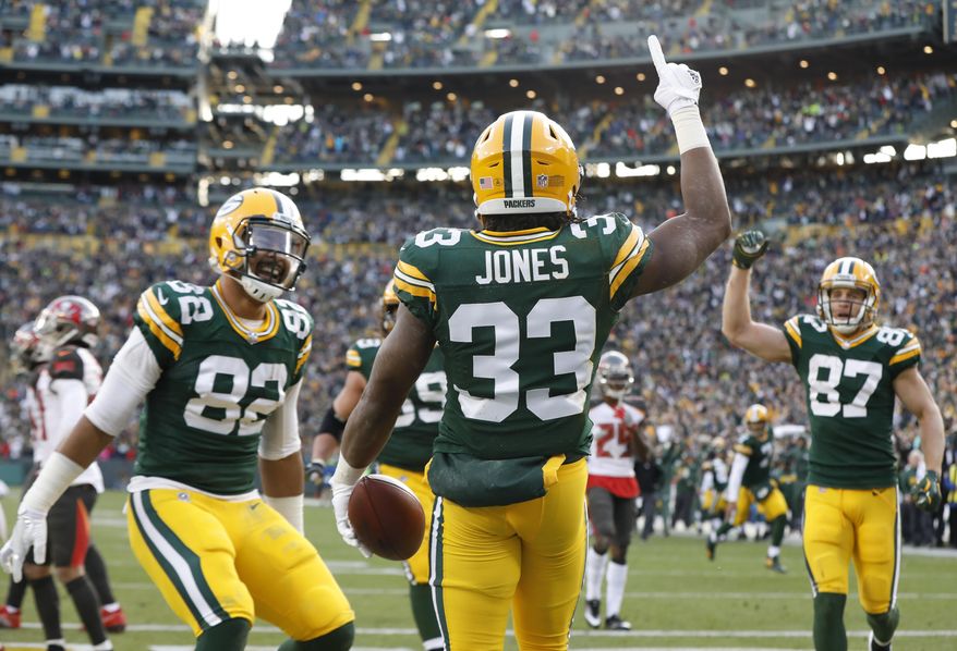 Green Bay Packers' Aaron Jones celebrates his touchdown run during overtime of an NFL football game against the Tampa Bay Buccaneers Sunday, Dec. 3, 2017, in Green Bay, Wis. The Packers won 26-20. (AP Photo/Mike Roemer)