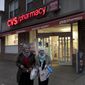 Customers leave a CVS Pharmacy, Sunday, Dec. 3, 2017, in the Brooklyn borough of New York. (AP Photo/Mark Lennihan) ** FILE **