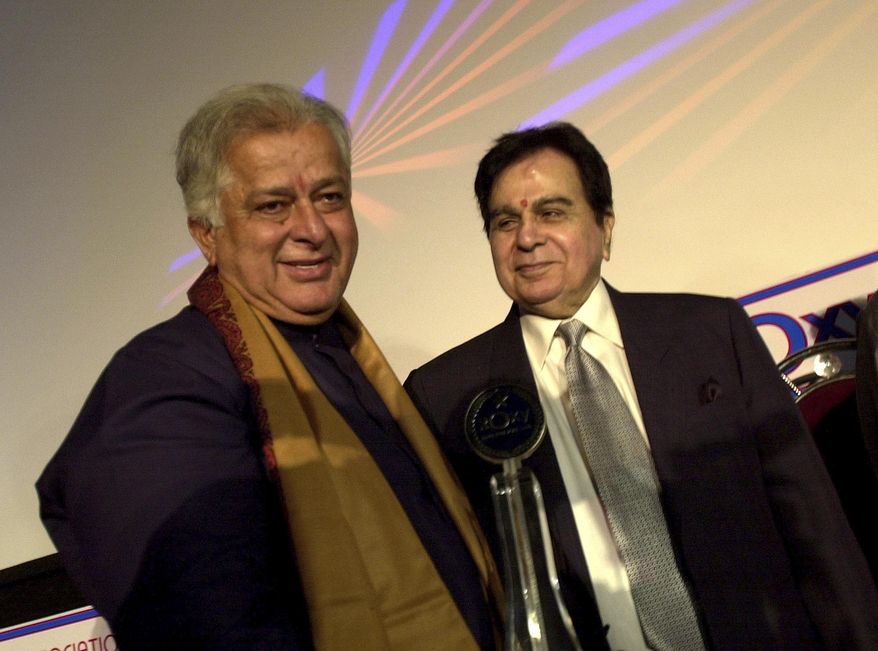 FILE- In this June 2, 2005 file photo, legendary Bollywood actor Dilip Kumar, right, looks at veteran actor Shashi Kapoor, left, at the inauguration of a new cinema in Mumbai, India. Kapoor was felicitated at the event. Kapoor, a prolific Bollywood actor and producer from the 1970s and '80s, died Monday, Dec. 4, 2017 after a long illness. He was 79. (AP Photo/Aijaz Rahi, File)