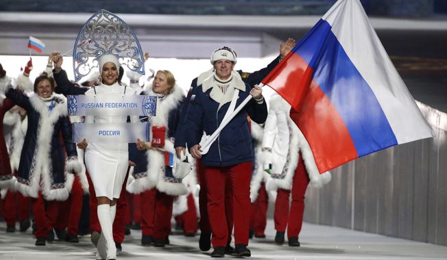 FILE - In this Feb. 7, 2014 file photo Alexander Zubkov of Russia carries the national flag as he leads the team during the opening ceremony of the 2014 Winter Olympics in Sochi, Russia. When the International Olympic Committee board prepares to vote Tuesday, Dec. 5, 2017 on whether to ban Russia from February’s Winter Olympics, its members will decide the fate of numerous medals yet to be won. (AP Photo/Mark Humphrey, file)