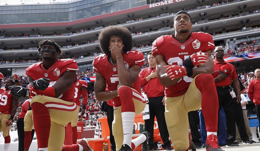 FILE - In this Oct. 2, 2016, file photo, San Francisco 49ers outside linebacker Eli Harold, left, quarterback Colin Kaepernick, center, and safety Eric Reid kneel during the national anthem before the team&#39;s NFL football game against the Dallas Cowboys in Santa Clara, Calif. Kaepernick accepted Sports Illustrated&#39;s Muhammad Ali Legacy Award from Beyonce on Tuesday night, Dec. 5, 2017, and promised that &quot;with or without the NFL&#39;s platform, I will continue to work for the people.&quot; Beyonce thanked Kaepernick for his &quot;personal sacrifice,&quot; and 2016 Ali Award winner Kareem Abdul-Jabbar called Kaepernick a &quot;worthy recipient&quot; during a video tribute. (AP Photo/Marcio Jose Sanchez) ** FILE **