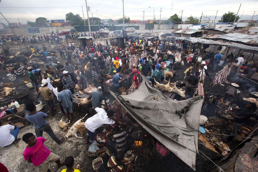 This Nov. 11, 2017 photo shows the a view of the La Saline slaughterhouse in Port-au-Prince, Haiti. The open-air market is a nightmarish panorama of animal blood, body parts and detritus. It&#39;s also an essential part of the economy of the Haitian capital, supplying meat to restaurants, street vendors and stores.(AP Photo/Dieu Nalio Chery)